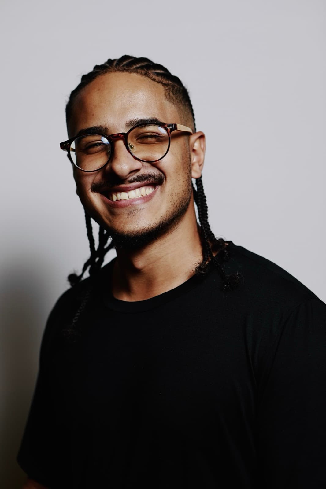 Retrato de João Guedes sorrindo, de camiseta preta